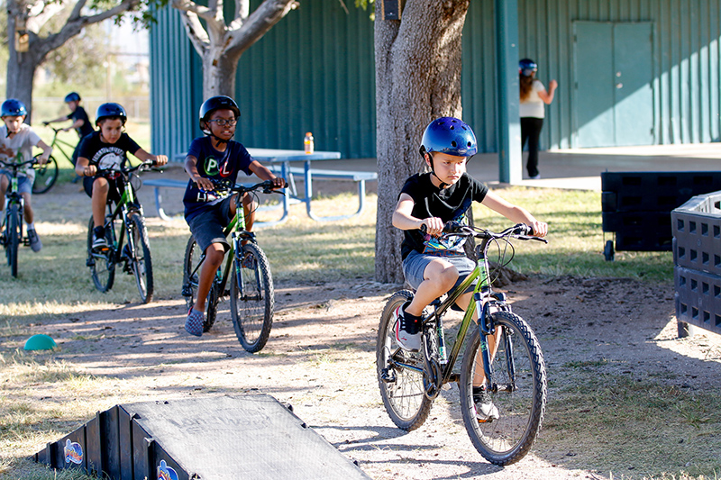 Students riding in a row.