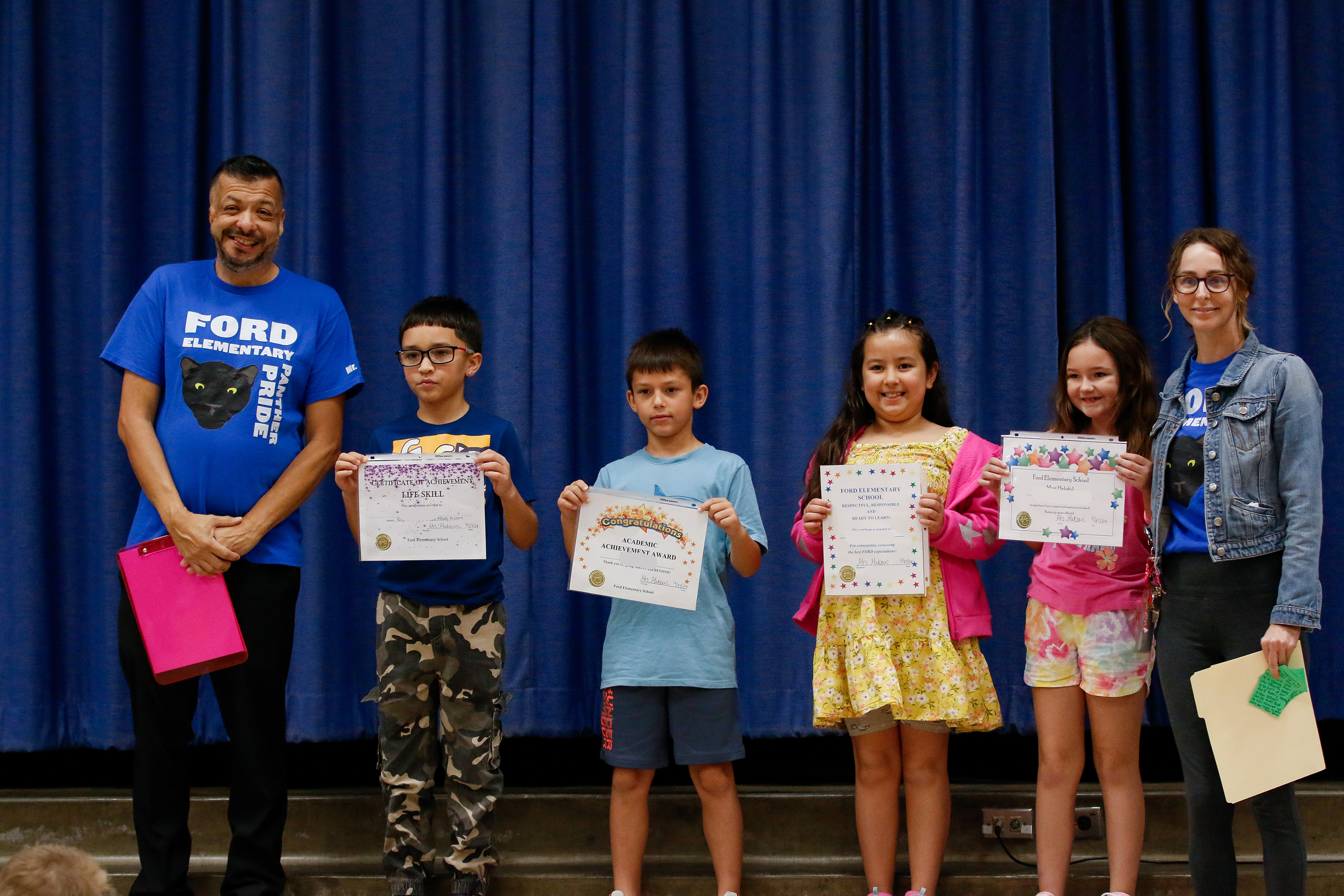 Ford students pose with their certificates and their proud principal