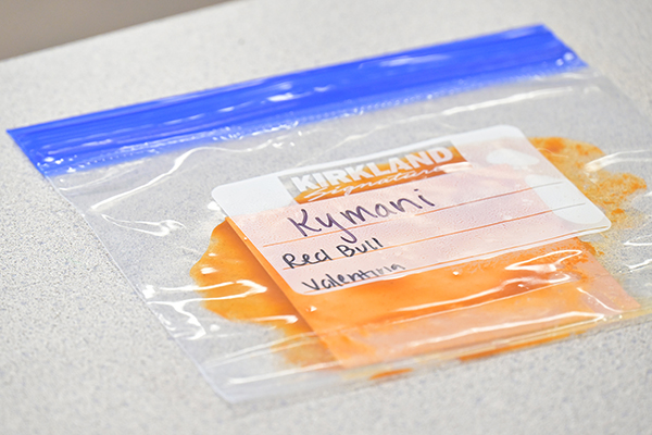 A plastic baggie filled with Valentina hot sauce and Red Bull